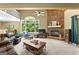 Spacious living room with stone fireplace, large window, and comfortable seating area at 335 Winding Stream Trl, Hampton, GA 30228