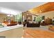 Open-concept living room and dining room with hardwood floors, stone fireplace, vaulted wood ceiling, and ample natural light at 335 Winding Stream Trl, Hampton, GA 30228