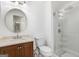 Updated bathroom with vanity, tile shower, and a round decorative mirror at 172 W Campbellton St, Fairburn, GA 30213