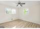 Clean bedroom with light wood flooring, ceiling fan, and lots of natural light at 172 W Campbellton St, Fairburn, GA 30213