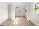 Bright bedroom with light wood floors, a ceiling fan, and mirrored closet doors at 172 W Campbellton St, Fairburn, GA 30213