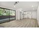 Bright, open kitchen with white cabinets, stainless steel sink, and sliding glass doors to the outside at 172 W Campbellton St, Fairburn, GA 30213
