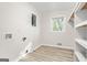 Laundry room with a window, hookups, and utility shelving at 172 W Campbellton St, Fairburn, GA 30213