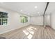 Bright and spacious living room featuring light wood floors, natural light, and neutral paint at 172 W Campbellton St, Fairburn, GA 30213