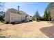 Sprawling backyard features a covered porch, fireplace, and manicured landscaping at 2358 New Salem Trce, Marietta, GA 30064