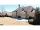 Backyard view with a hot tub on a concrete patio and a well-maintained lawn at 2358 New Salem Trce, Marietta, GA 30064