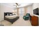 This bedroom provides a tranquil space with a ceiling fan, TV, and a comfy chair at 2358 New Salem Trce, Marietta, GA 30064