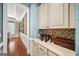 Charming butler's pantry featuring cream cabinetry and a wine collection at 2358 New Salem Trce, Marietta, GA 30064