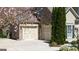 Traditional brick home has attached two-car garage, flowering trees, and landscaped yard at 2358 New Salem Trce, Marietta, GA 30064