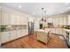 Spacious kitchen with white cabinets, stainless steel appliances, and hardwood floors at 2358 New Salem Trce, Marietta, GA 30064