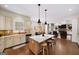 Bright, open kitchen with a center island, white cabinetry, and a view into the adjacent living area at 2358 New Salem Trce, Marietta, GA 30064