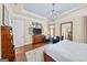 Bright main bedroom with hardwood floors, a blue ceiling, and a decorative picture arrangement at 2358 New Salem Trce, Marietta, GA 30064