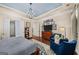 Cozy main bedroom with hardwood floors, a blue ceiling, and a comfortable seating area at 2358 New Salem Trce, Marietta, GA 30064