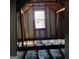 Unfinished attic space featuring exposed wooden beams and framing, with a centered window offering natural light at 3650 Bay Leaf Dr, Loganville, GA 30052