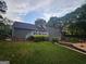 Spacious backyard with a manicured lawn, inviting deck, and luxurious swimming pool at 3650 Bay Leaf Dr, Loganville, GA 30052