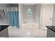 Bright bathroom featuring tile flooring, a garden tub with an oval window, and a separate shower at 3650 Bay Leaf Dr, Loganville, GA 30052