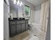 Bathroom showcasing a vanity with black countertop and a shower-tub combo at 3650 Bay Leaf Dr, Loganville, GA 30052