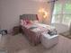 Bright bedroom featuring a comfortable bed, plush pillows and natural light from a large window at 3650 Bay Leaf Dr, Loganville, GA 30052