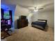 Bedroom features a ceiling fan, carpet flooring, desk, dresser, television, and queen-size bed at 3650 Bay Leaf Dr, Loganville, GA 30052