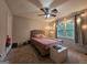 Bedroom featuring a ceiling fan, windows with natural light, carpeted flooring, and neutral walls at 3650 Bay Leaf Dr, Loganville, GA 30052