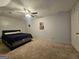 Bedroom with carpet flooring, ceiling fan, poster on the wall and queen size bed at 3650 Bay Leaf Dr, Loganville, GA 30052