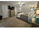 Bedroom featuring a ceiling fan, TV, dresser, and carpeted flooring at 3650 Bay Leaf Dr, Loganville, GA 30052
