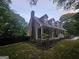 Charming home exterior featuring a covered front porch, dormer windows, and lush landscaping at 3650 Bay Leaf Dr, Loganville, GA 30052