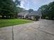Charming home featuring lush landscaping, a well-manicured lawn, and a paved driveway at 3650 Bay Leaf Dr, Loganville, GA 30052