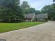 Inviting home with a long driveway, well-manicured lawn, and charming front porch at 3650 Bay Leaf Dr, Loganville, GA 30052