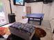 Basement game room features a ping pong table, plush ottoman, and walkout access at 3650 Bay Leaf Dr, Loganville, GA 30052