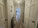 Hallway featuring hardwood flooring, neutral paint and doors leading to other areas of the home at 3650 Bay Leaf Dr, Loganville, GA 30052