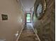 Hallway features herringbone accent wall, hardwood floors, white trim, and red front door at 3650 Bay Leaf Dr, Loganville, GA 30052