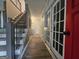 Entrance hallway with hardwood flooring, stairs with iron railing, and a red front door at 3650 Bay Leaf Dr, Loganville, GA 30052