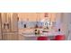Well-lit kitchen with white cabinetry, marble countertops, and stainless steel refrigerator at 3650 Bay Leaf Dr, Loganville, GA 30052