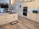 Open kitchen with white cabinets, subway tile backsplash, and stainless steel appliances at 3650 Bay Leaf Dr, Loganville, GA 30052