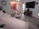 Bright living room featuring hardwood floors, a large sectional sofa, and a modern entertainment center at 3650 Bay Leaf Dr, Loganville, GA 30052