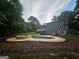 Backyard view showcasing a sparkling pool and a stone-trimmed hot tub at 3650 Bay Leaf Dr, Loganville, GA 30052