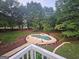 An inviting kidney-shaped pool is surrounded by a beautiful wooded backyard perfect for outdoor entertaining at 3650 Bay Leaf Dr, Loganville, GA 30052