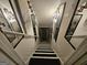 Stairway with black and white striped treads and decorative mirrors lining the wall at 3650 Bay Leaf Dr, Loganville, GA 30052