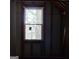 Interior shot of an unfinished attic with a wood-framed window, providing natural light and a view of the outdoors at 3650 Bay Leaf Dr, Loganville, GA 30052