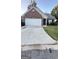 Cozy brick home featuring an attached two-car garage and well-maintained front yard at 4194 Wesley Hall Ln, Decatur, GA 30035
