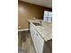 Bright kitchen view showcasing granite countertops, stainless steel sink and faucet, and wooden vinyl flooring at 4194 Wesley Hall Ln, Decatur, GA 30035