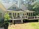 Backyard of house featuring a spacious deck and stairs at 100 Parliament Ct, Fayetteville, GA 30215