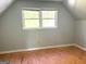 Upstairs bedroom featuring double windows and wood subfloor at 100 Parliament Ct, Fayetteville, GA 30215