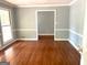 Spacious dining room with hardwood floors, and gray neutral colored walls with white trim at 100 Parliament Ct, Fayetteville, GA 30215
