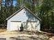Two car detached garage with traditional garage doors at 100 Parliament Ct, Fayetteville, GA 30215