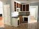 Kitchen featuring white shaker cabinets, dark countertops, tile flooring and a serving hatch at 100 Parliament Ct, Fayetteville, GA 30215