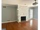 Living room with hardwood floors, a gray painted stone fireplace and a ceiling fan at 100 Parliament Ct, Fayetteville, GA 30215