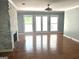 Living room featuring hardwood floors, a brick fireplace, a ceiling fan and access to a patio at 100 Parliament Ct, Fayetteville, GA 30215