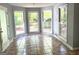 Sunny sunroom features multiple windows and tile floors at 100 Parliament Ct, Fayetteville, GA 30215